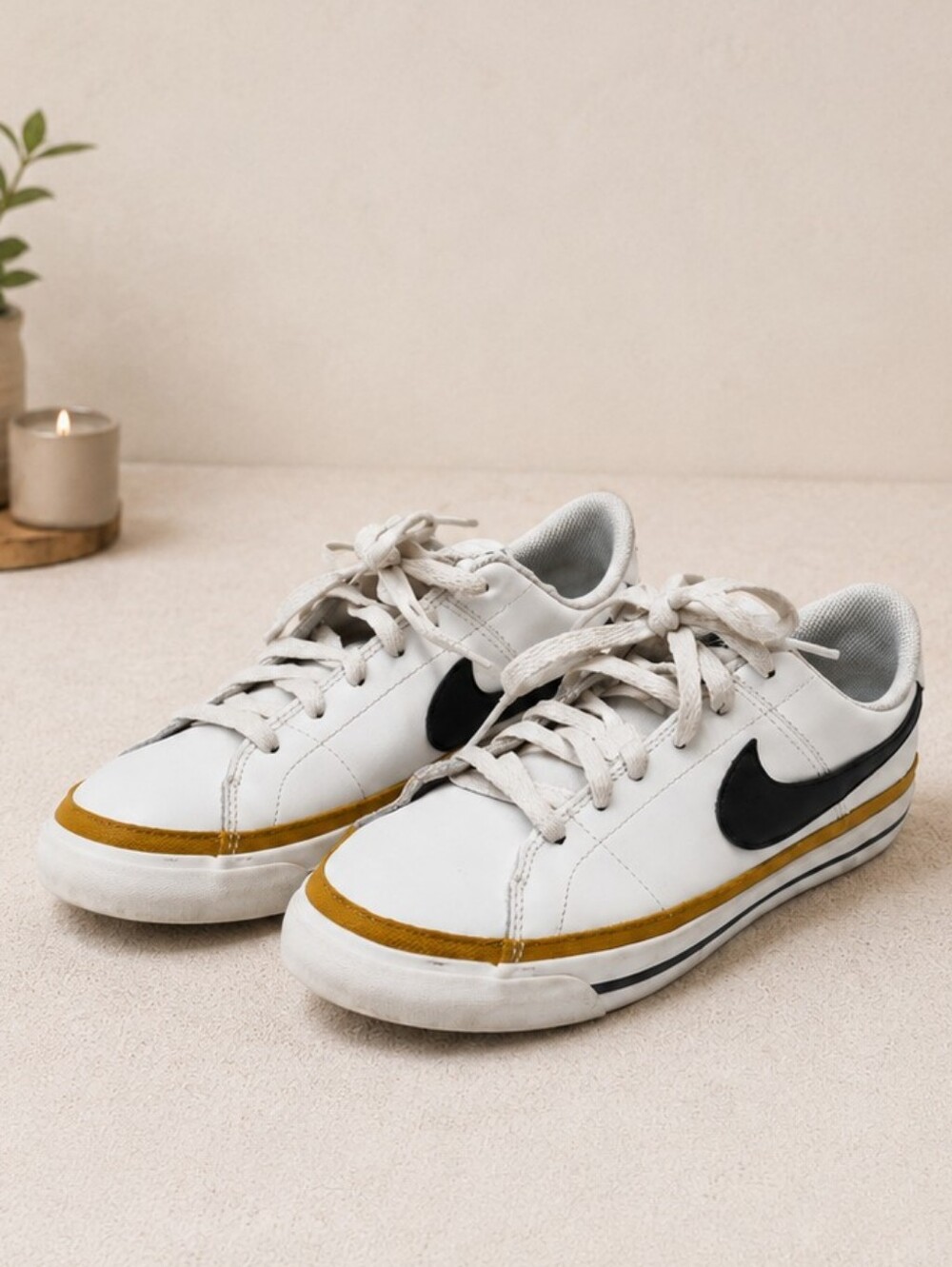 Nike Kids White Sneakers with Black Swoosh and Gold Stripe